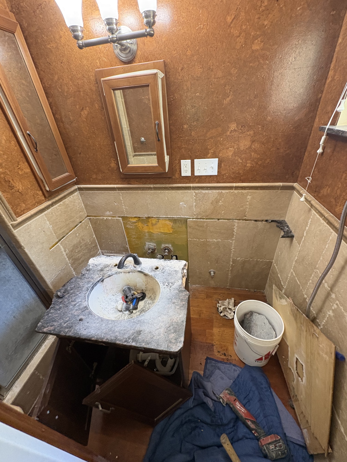 Bathroom remodel in progress — vanity and tile demo
