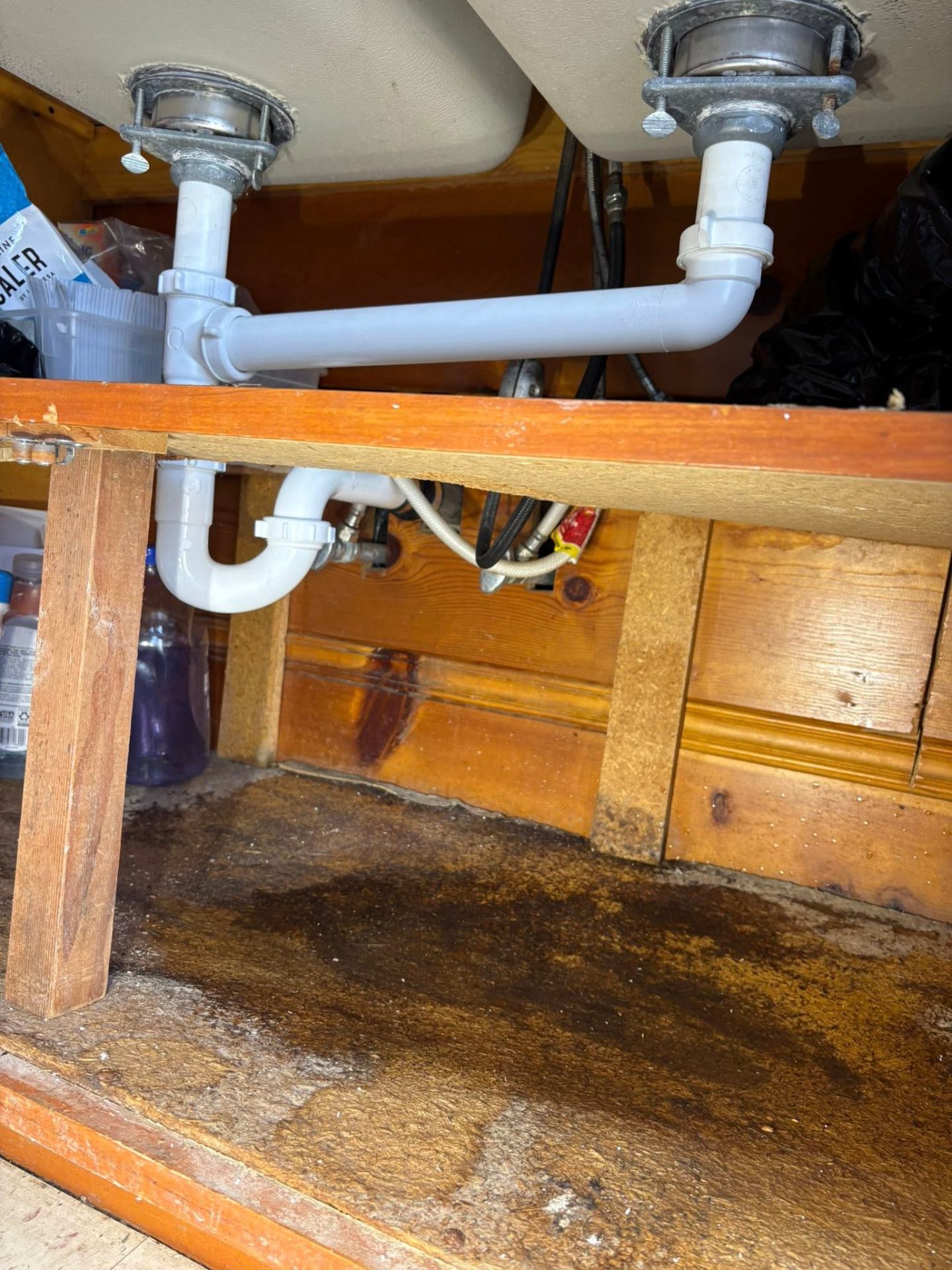 Under-sink leak repair and water damage cleanup