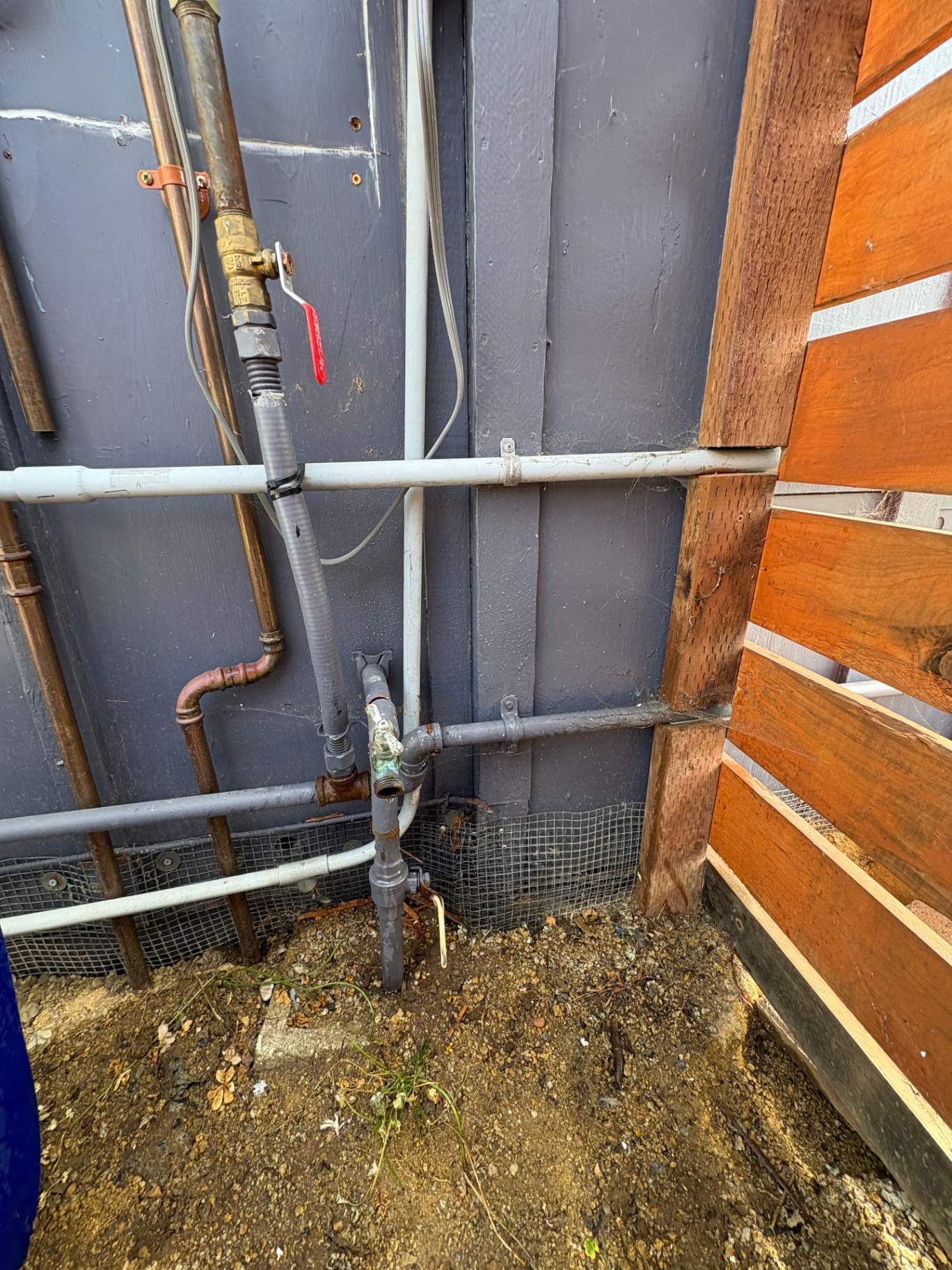 Exterior water and gas line repipe at building corner