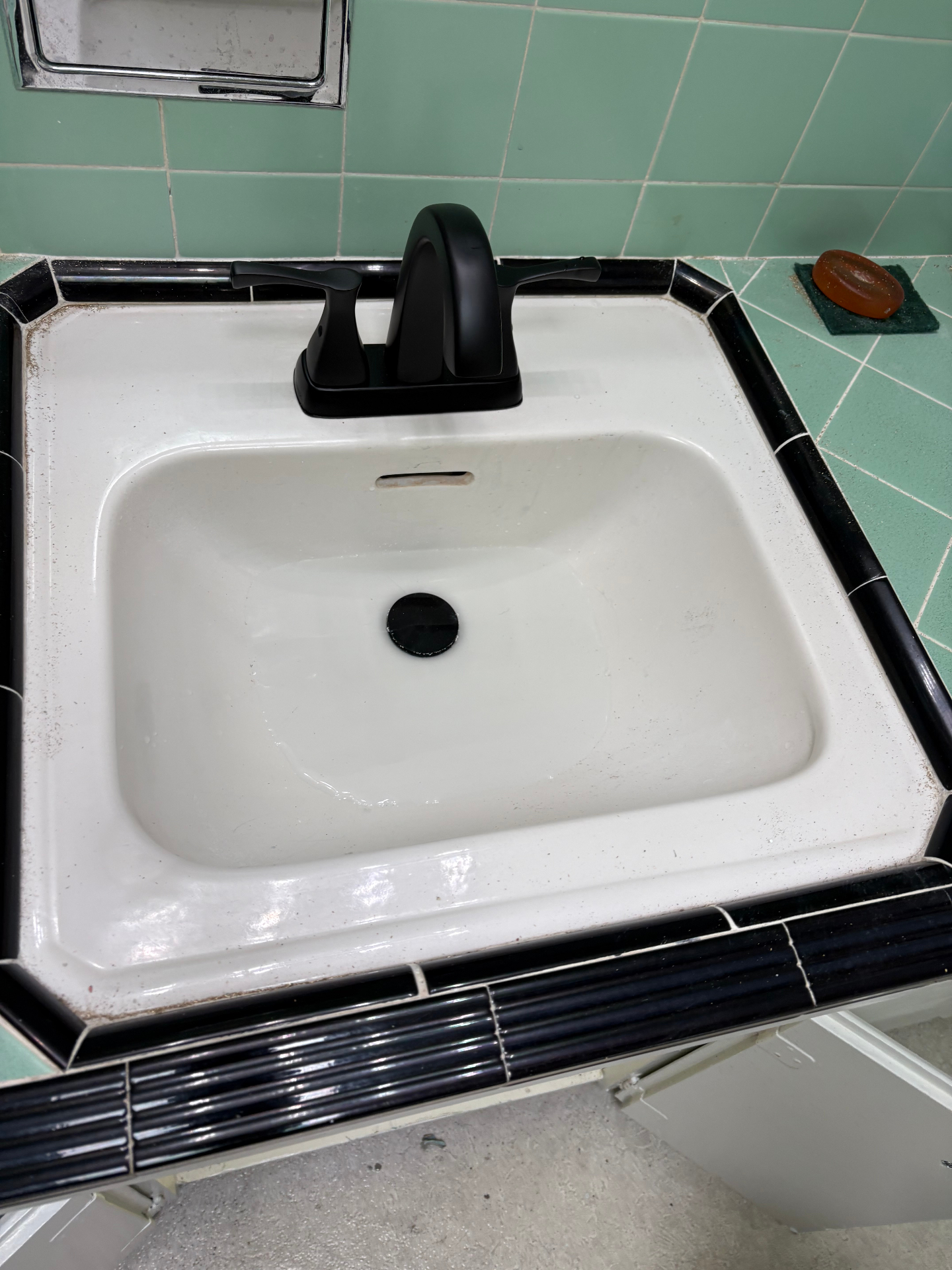 Bathroom faucet replacement — new matte black faucet after